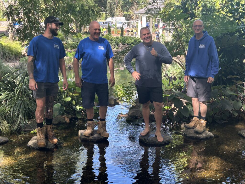 Greg Wittstock and Pond Works team in Pond Works wetland ecosystem pond