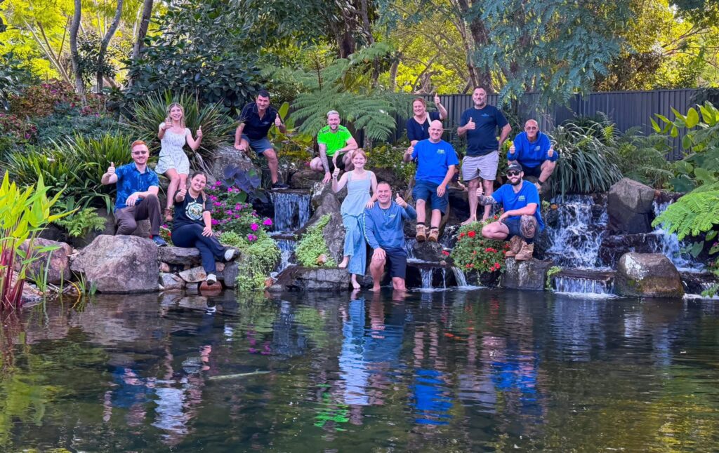 Pond Works team with international pond influencers on a grand waterfall ecosystem pond with constructed wetland