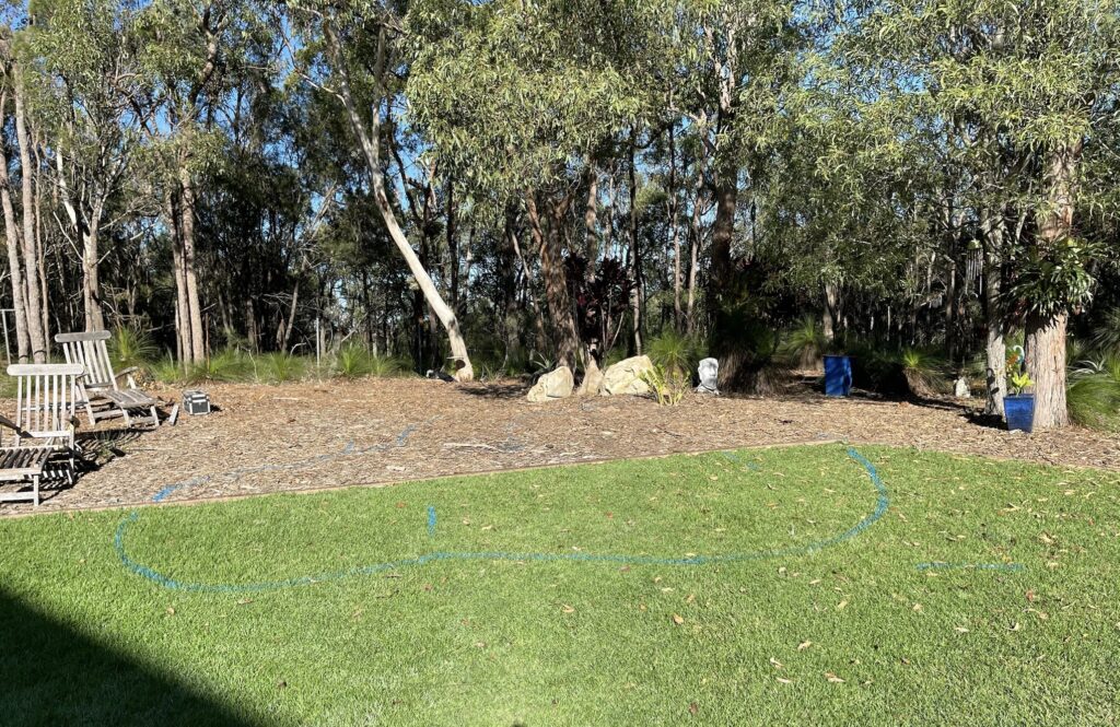 Flat planted backyard area in Burbank, Queensland before construction of a natural ecosystem pond and twin waterfall feature by Pond Works.