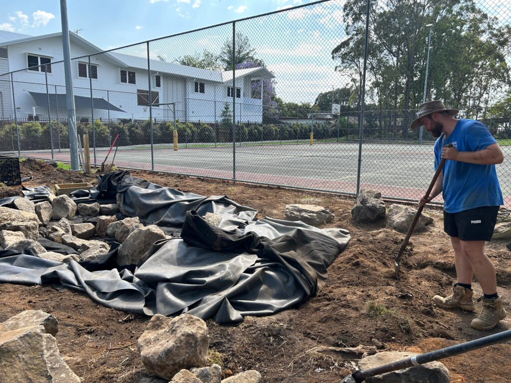 Bailey preparing materials for next stage of pond construction at Kallangur State School