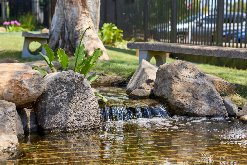 Small waterfall flowing into pond at Kallangur State School water feature construction